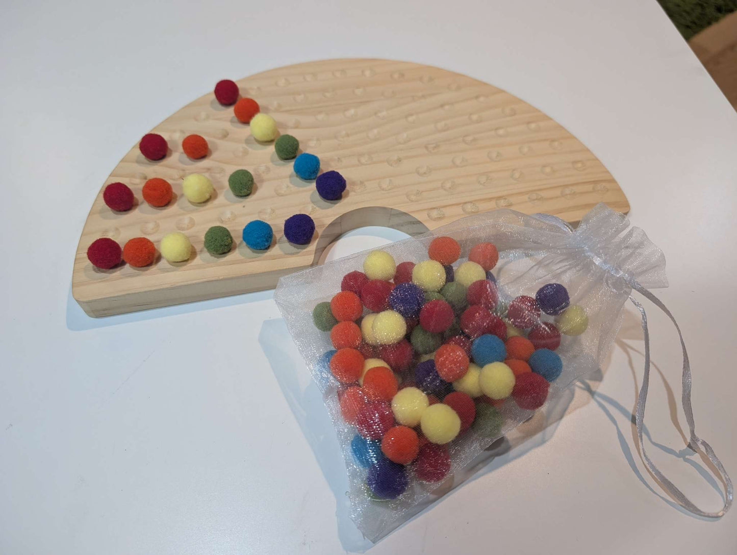 Educational wooden rainbow with pom poms