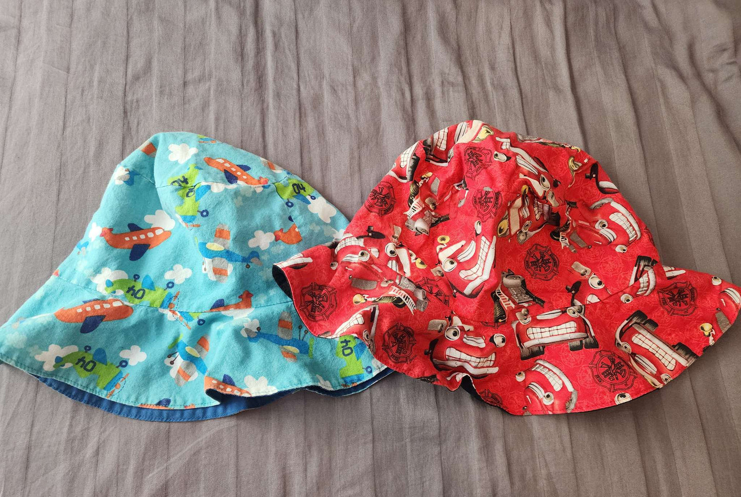 2 over sized sun hats size 4-6- fire trucks & planes