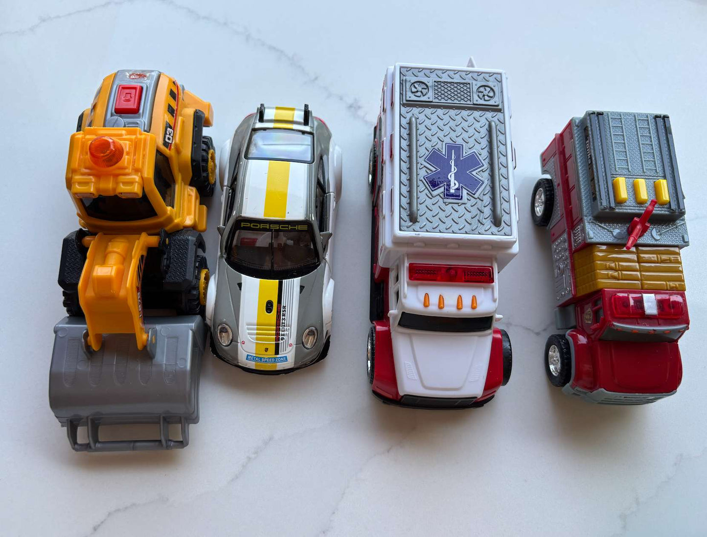 Toy car lot; tractor, firetruck, ambulance