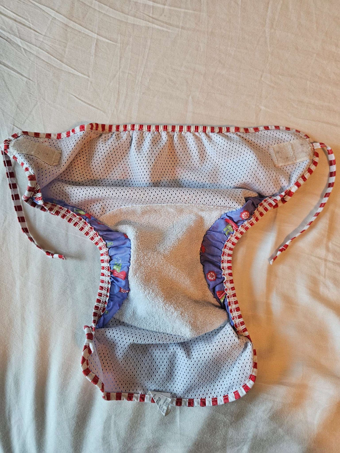 Size medium Kushies reusable swim diaper (purple boats) MSRP $16.99, Kids 12 Month (9-12M)