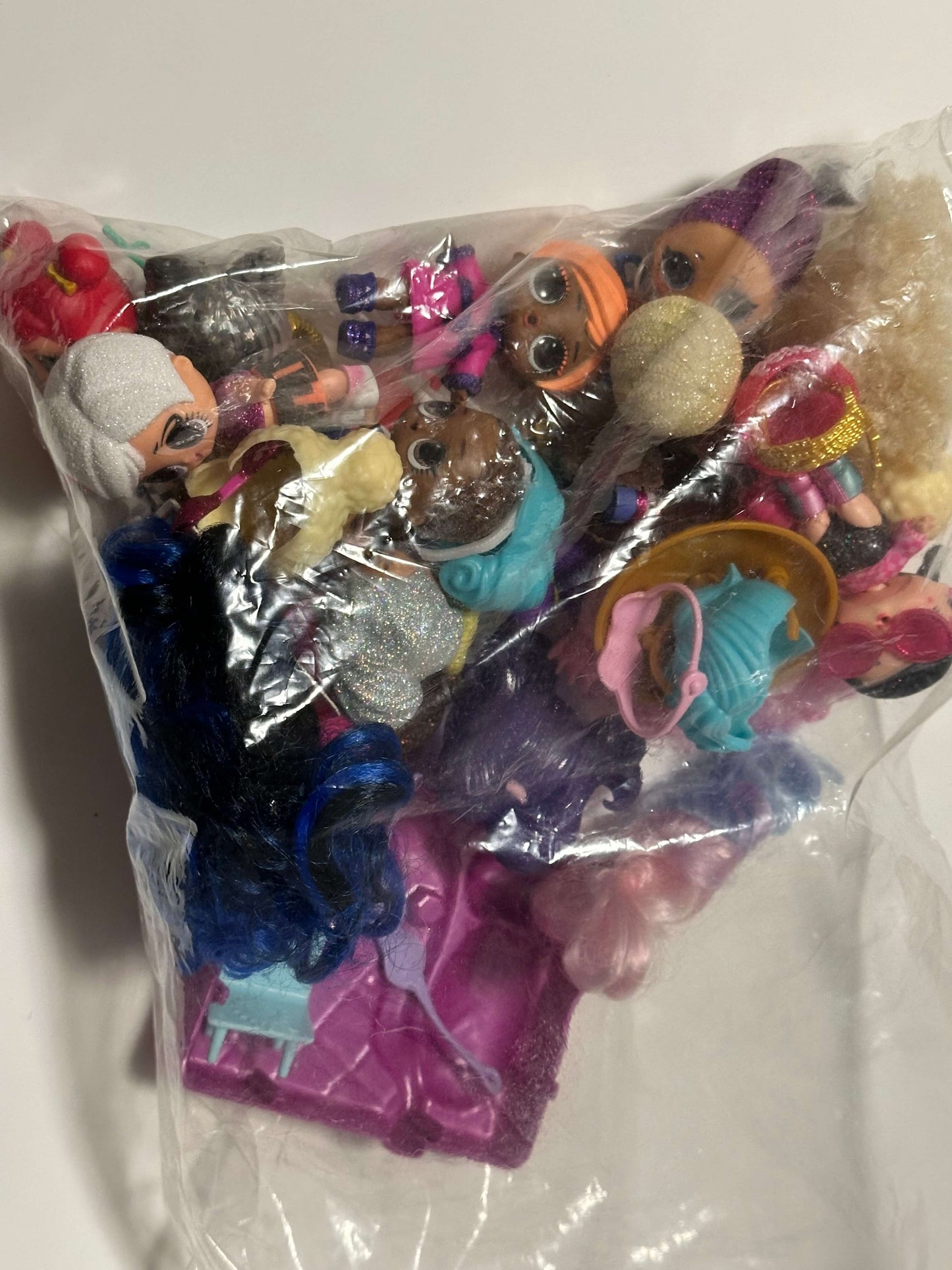 Bag of LOL dolls and accessories