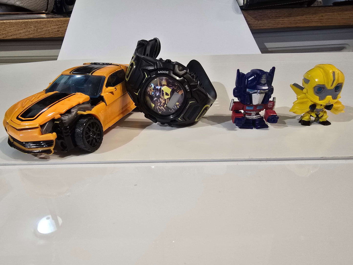 Transformers watch, figurines and Bumblebee car that can be transformed into bot