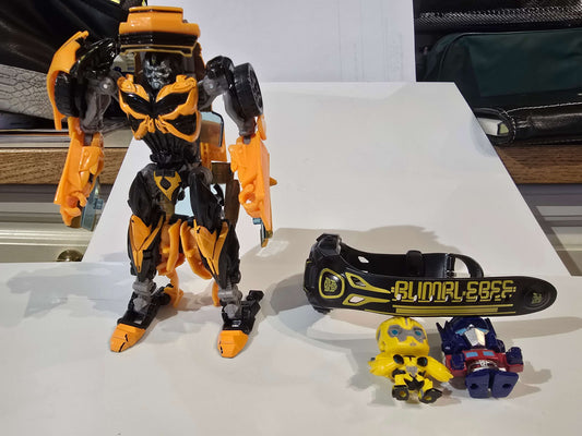 Transformers watch, figurines and Bumblebee car that can be transformed into bot