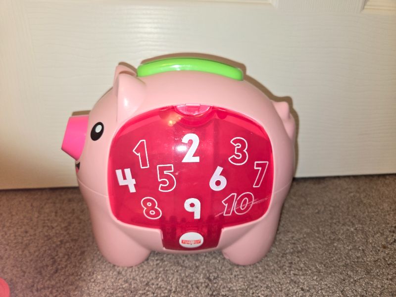 Piggie bank toy. English and French words