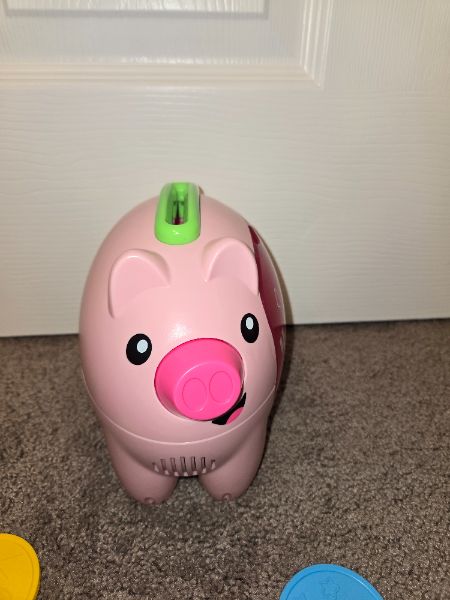 Piggie bank toy. English and French words