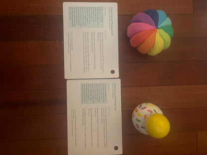 Lovevery tummy time wobbler and organic cotton rainbow ball