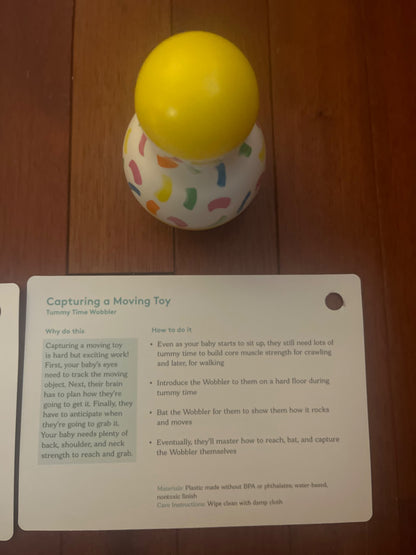Lovevery tummy time wobbler and organic cotton rainbow ball