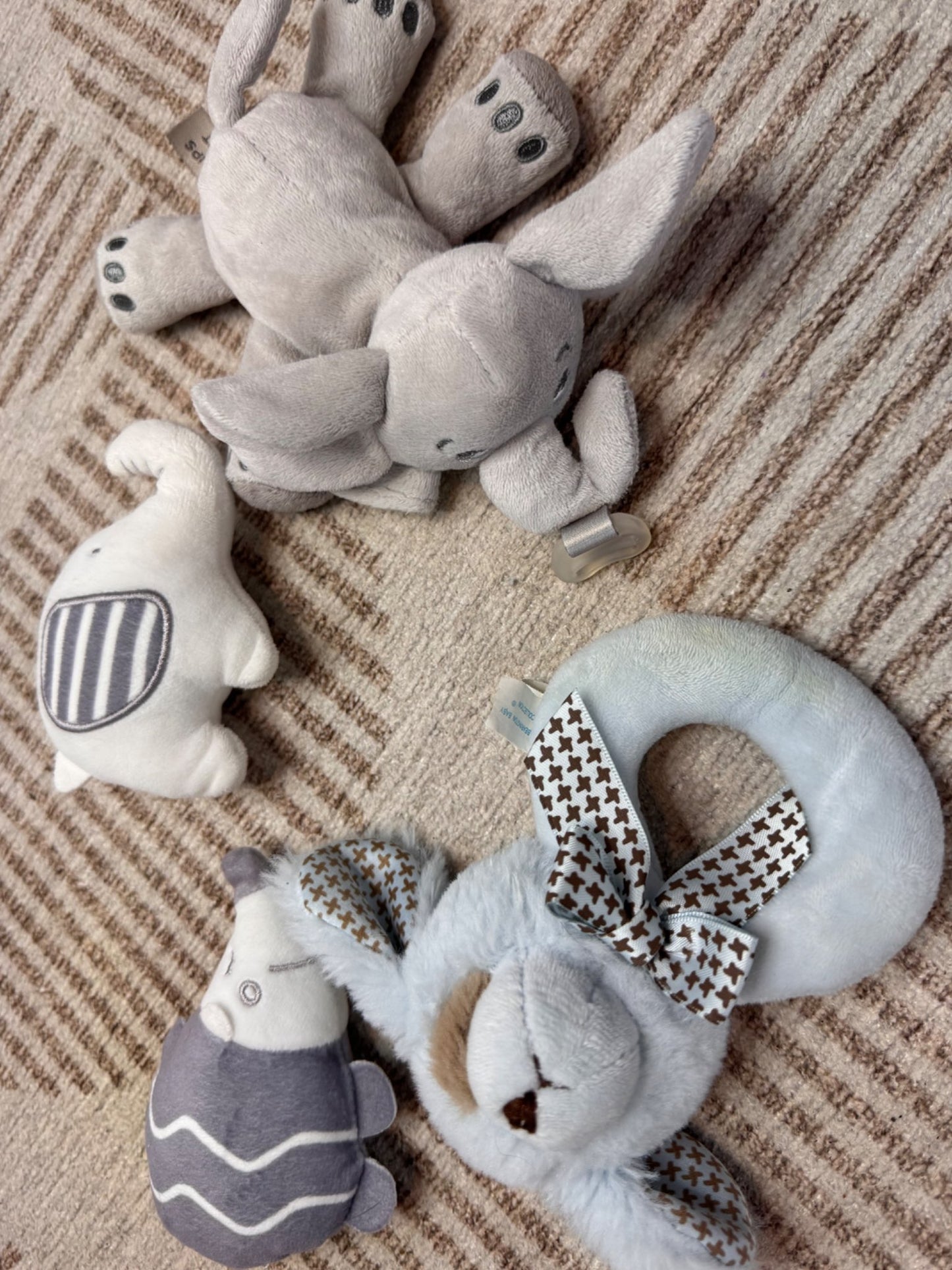 3 baby rattles and an Elephant Soother Holder