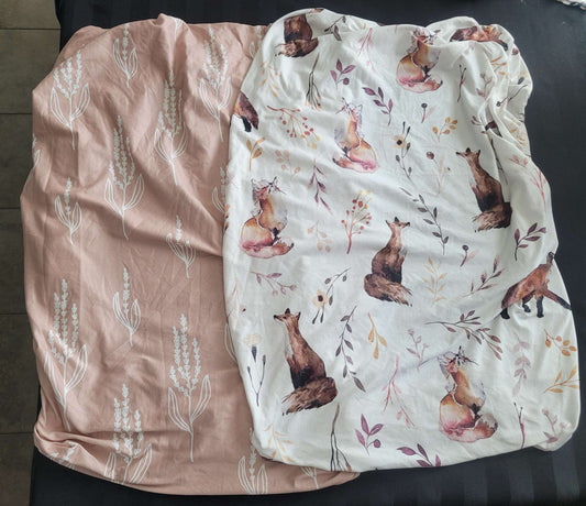 Two changing pad covers, pink and fox patterns