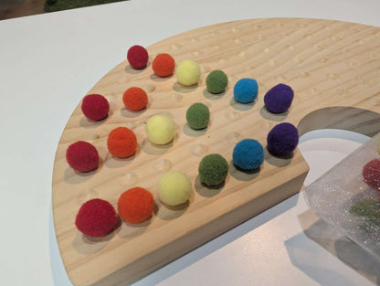 Educational wooden rainbow with pom poms