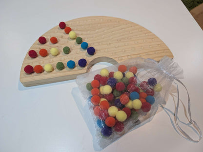 Educational wooden rainbow with pom poms