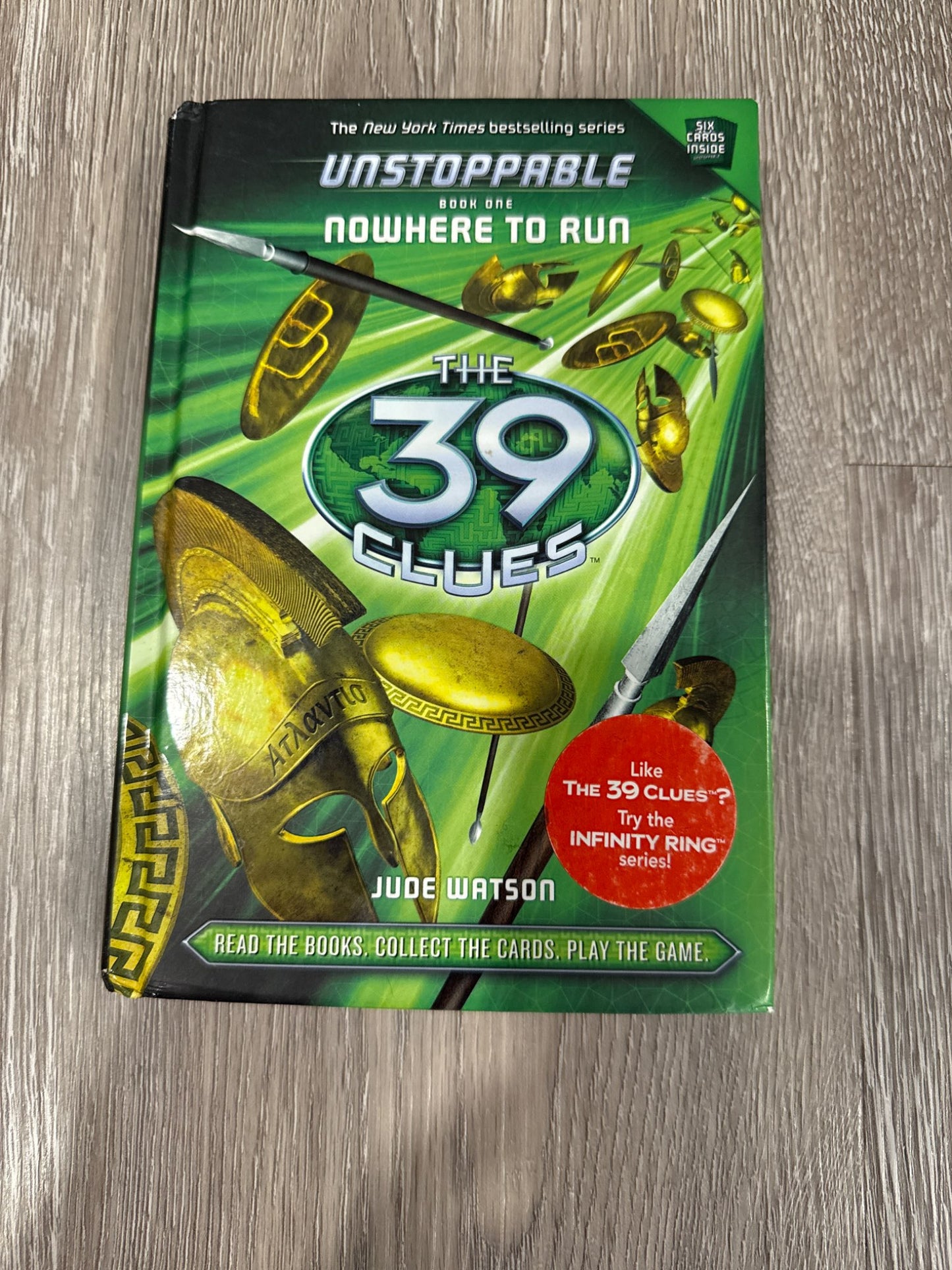 Two of the famous 39 Clues books The Maze of Bones and Nowhere to Run