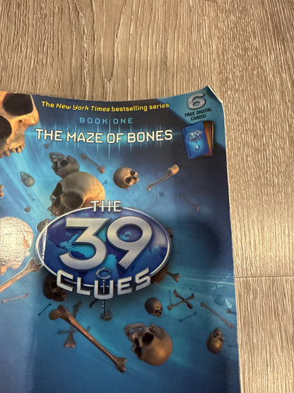 Two of the famous 39 Clues books The Maze of Bones and Nowhere to Run