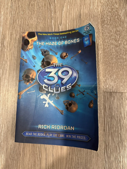 Two of the famous 39 Clues books The Maze of Bones and Nowhere to Run