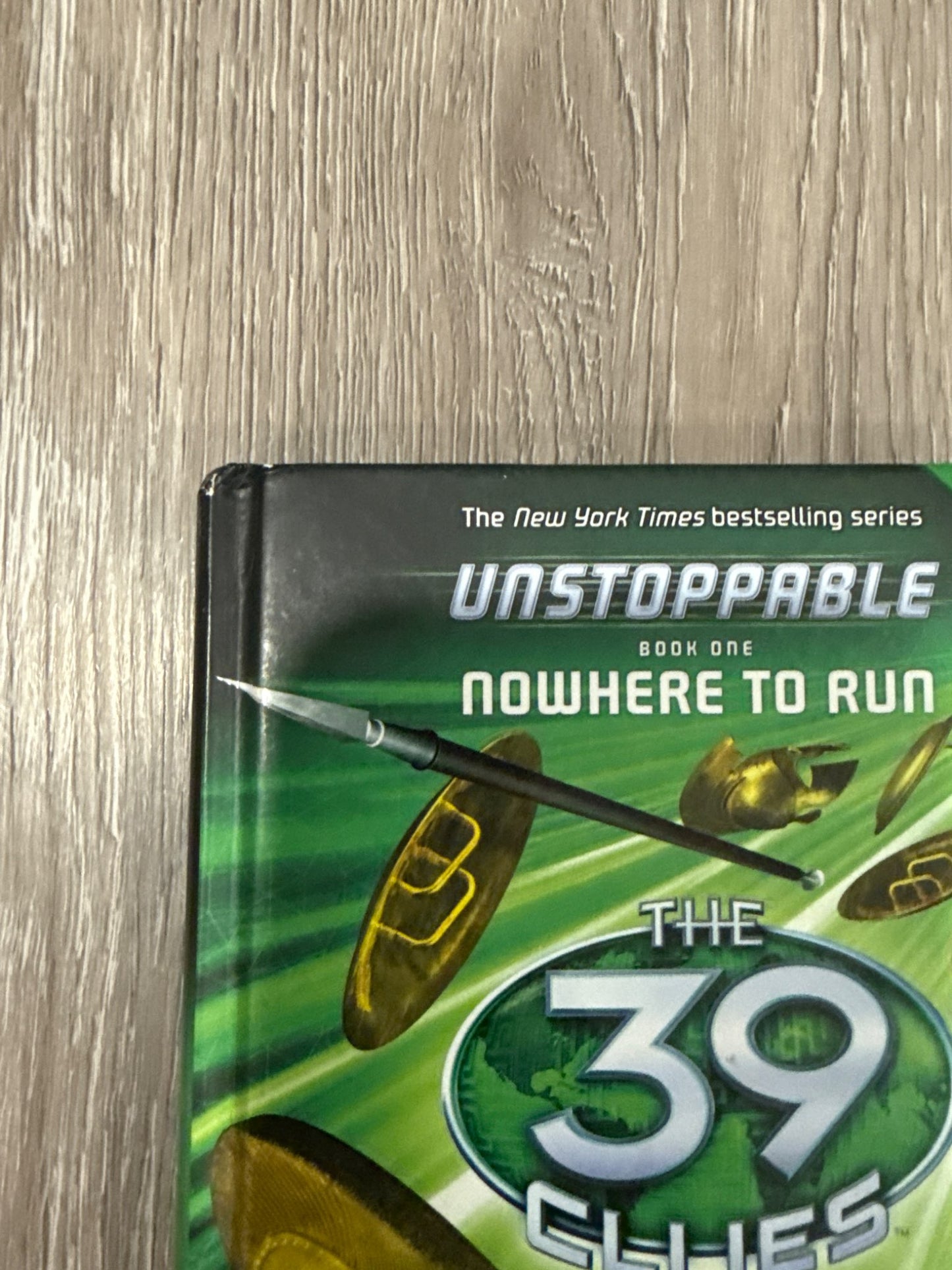 Two of the famous 39 Clues books The Maze of Bones and Nowhere to Run