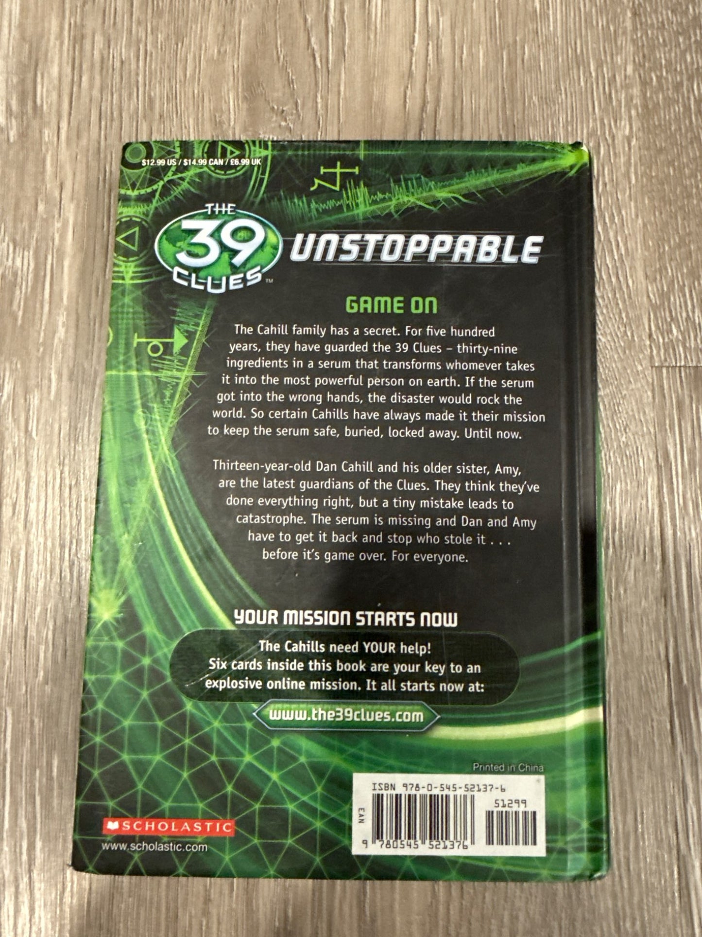 Two of the famous 39 Clues books The Maze of Bones and Nowhere to Run