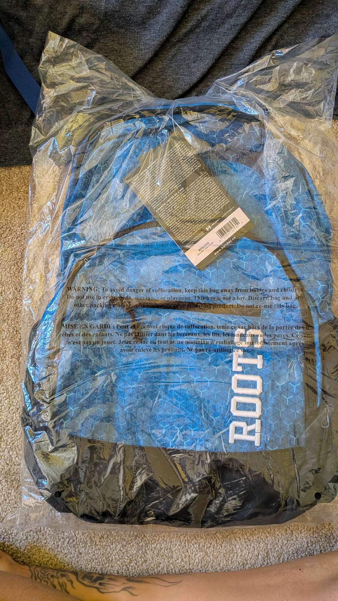 Brand new in package blue Roots backpack