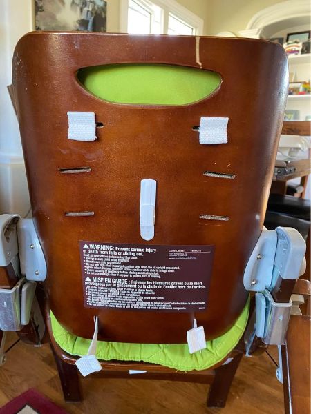 Brown highchair with removable lime green padding and tray