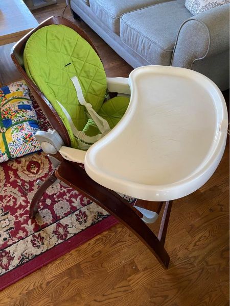 Brown highchair with removable lime green padding and tray