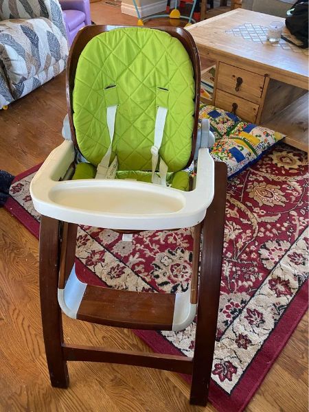 Brown highchair with removable lime green padding and tray