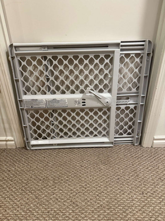 Grey plastic pressure mount baby gate