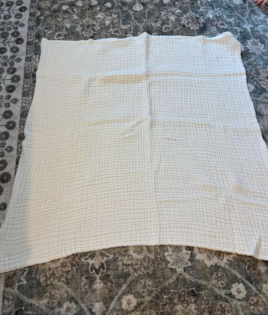 White muslin baby blanket