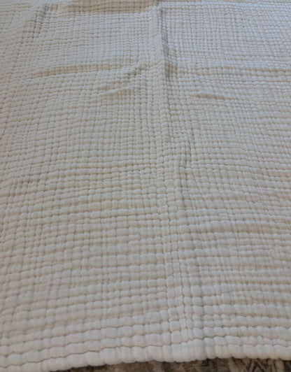 White muslin baby blanket