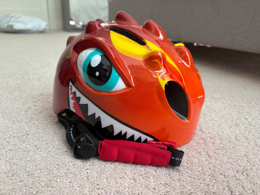 New - dinosaur bike helmet, never used, retails $30, 50-54cm head circumference