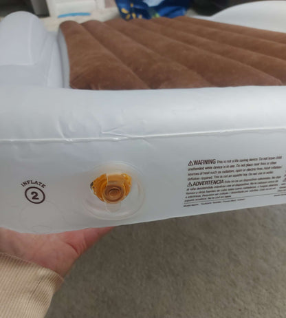 Inflatable travel bed with safety bumpers
