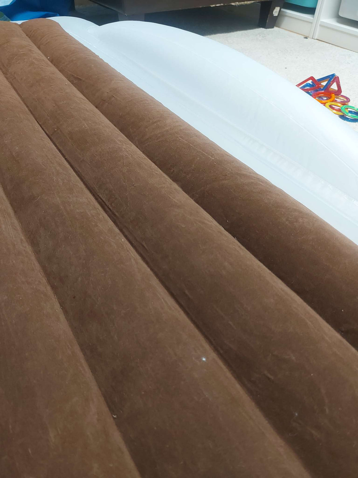 Inflatable travel bed with safety bumpers