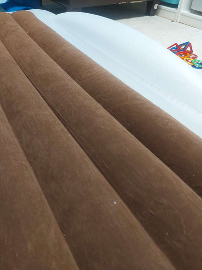 Inflatable travel bed with safety bumpers