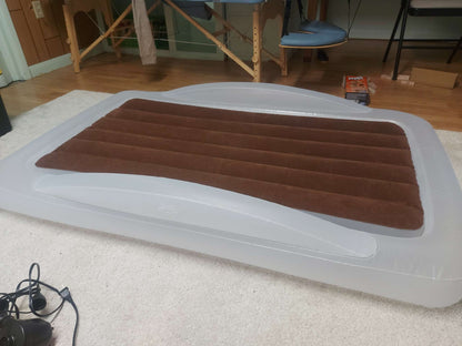 Inflatable travel bed with safety bumpers