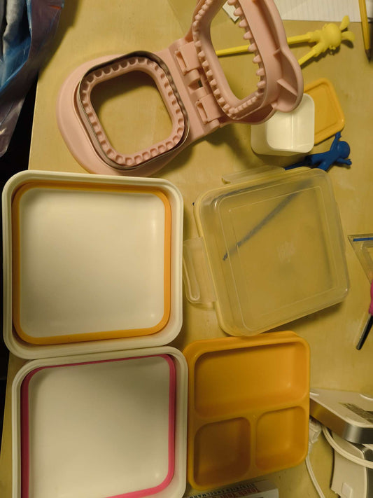 Lunch containers, chopsticks and bread cutter