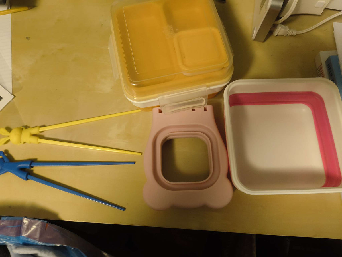 Lunch containers, chopsticks and bread cutter