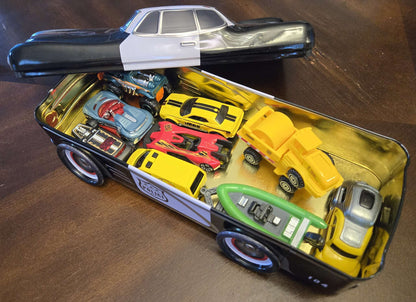 Car-shaped tin full of toy cars!