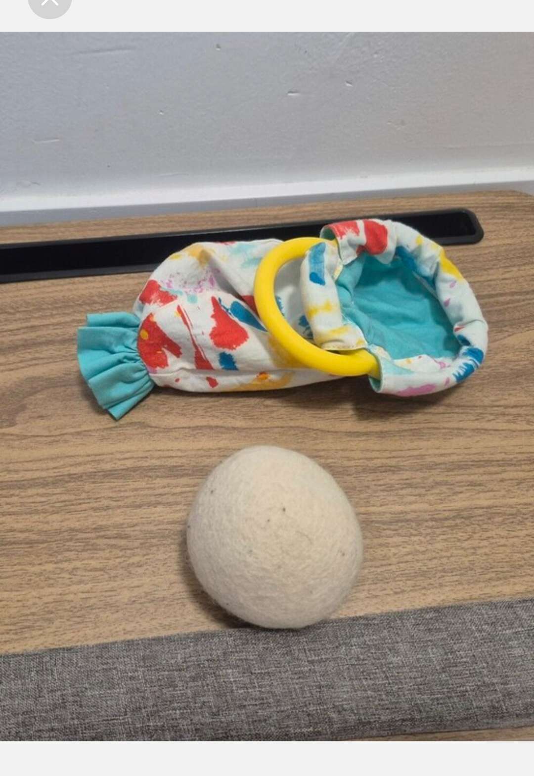 Lovevery Organic Cotton Sensory Pouch with a yellow ring And Ball