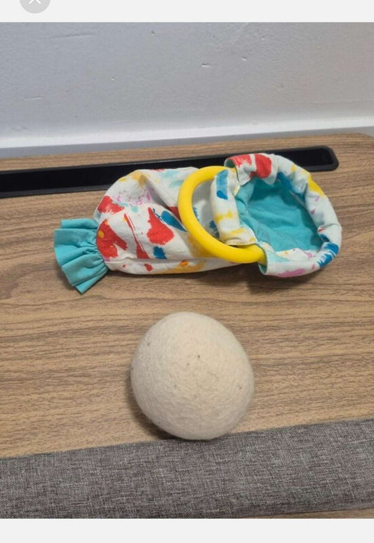 Lovevery Organic Cotton Sensory Pouch with a yellow ring And Ball