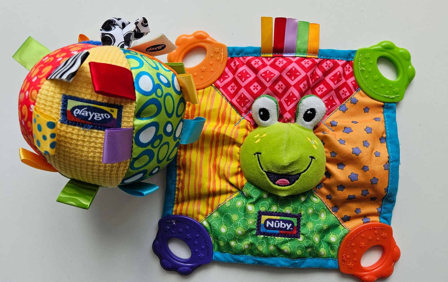 Set of 2 soft baby toys (Nuby frog cloth and playgro musical ball)