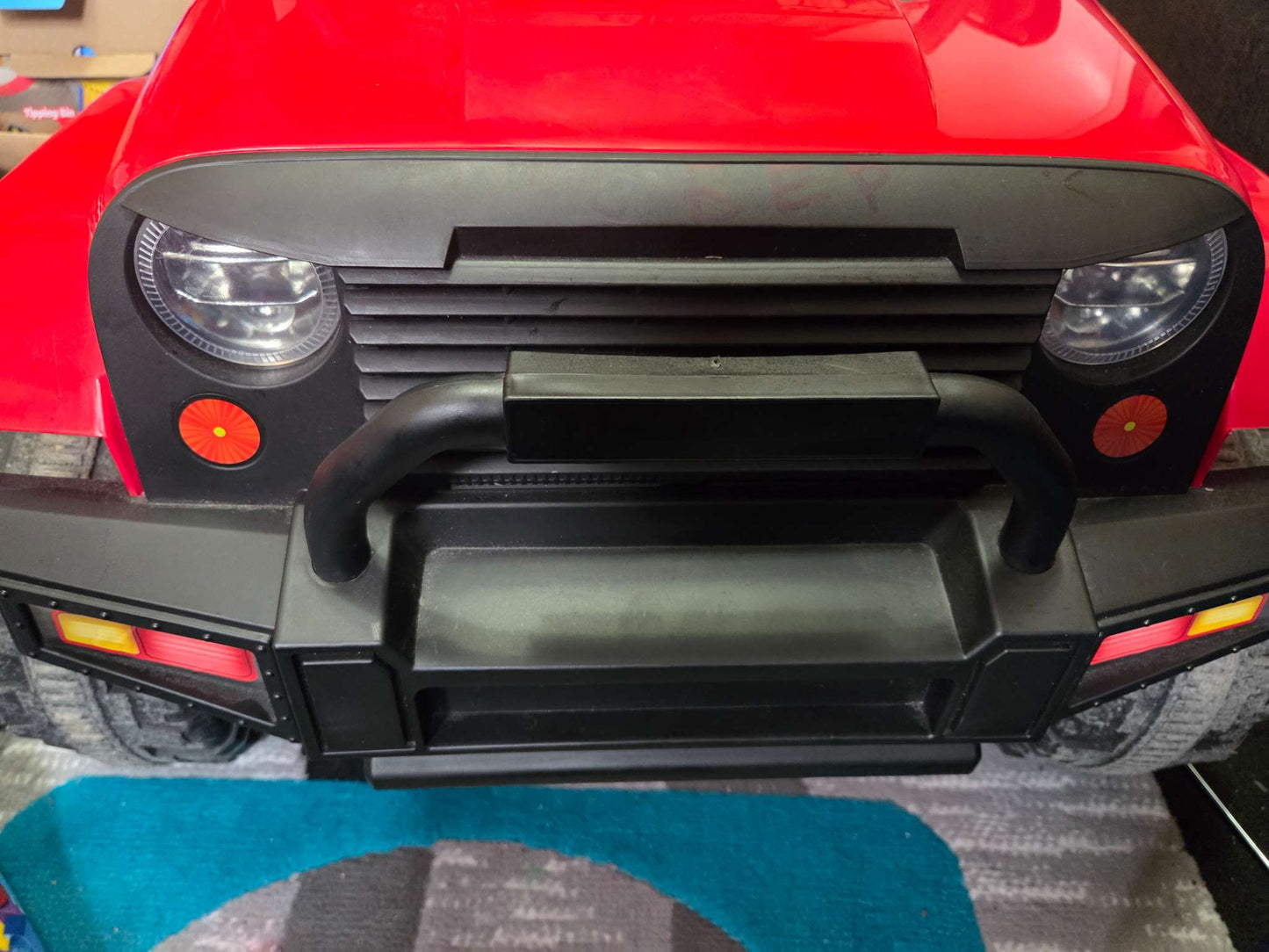 Red Ride-on Truck, with remote control and seatbelt, music, and headlights (Retails, $259.99)